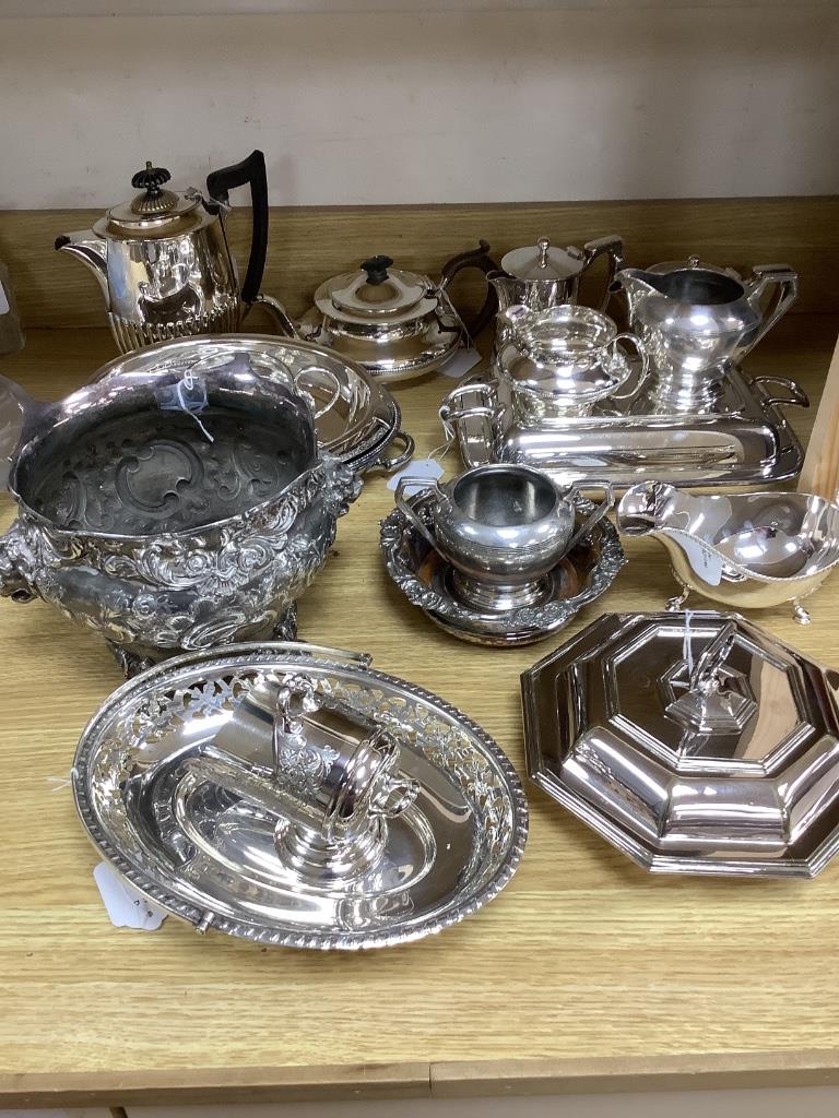 A collection of plated items, including a three-piece tea service, four entrée dishes and covers, various